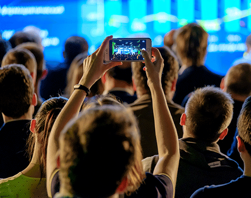 Person filming a concert on their phone.