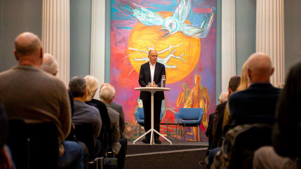 Enrico Letta on stage with audience in front