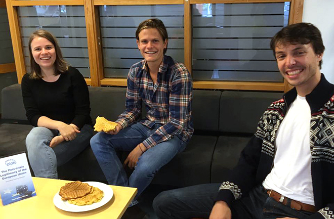Three smiling people eating Norwegian waffles: Claire Godet, Joris Melman, Jan Pesl