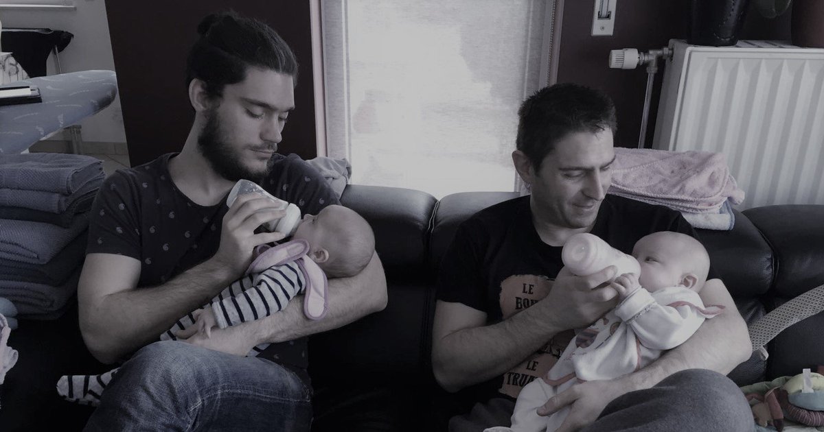 Two men holding babies. 