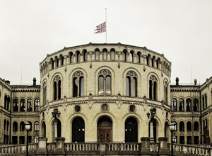 The front of the Nowegian Parliament, with the flag at half-mast.