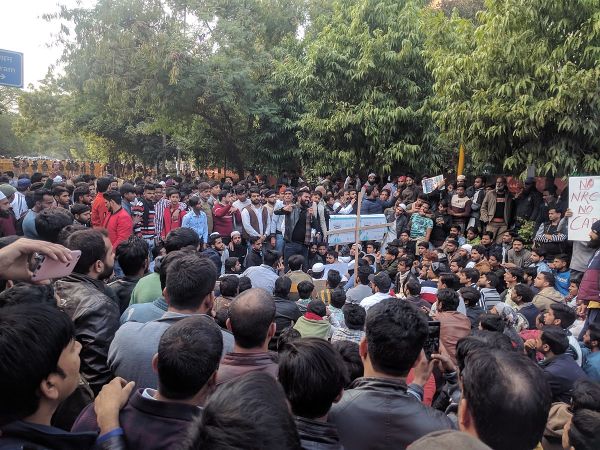 large group of people in a park during a protest