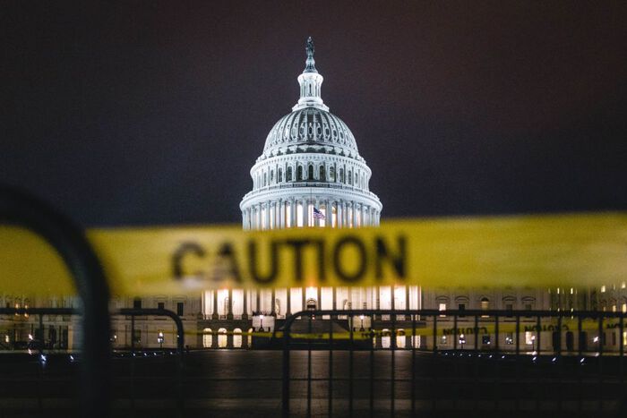 us state capitol with a caution banner in front