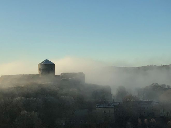round building in misty landscape