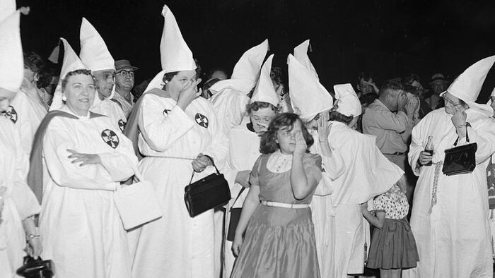 black and white photo of women with ku klux klan outfits