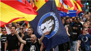 demonstration with spanish and hogar social flags