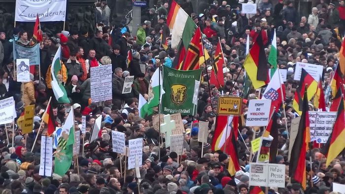 big crowd with different coloured flags