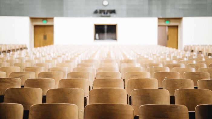rows of empty chairs in a large conference room