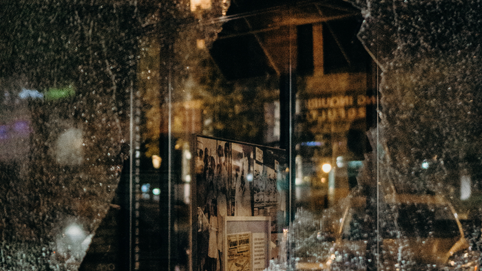 view through broken window at night in urban setting