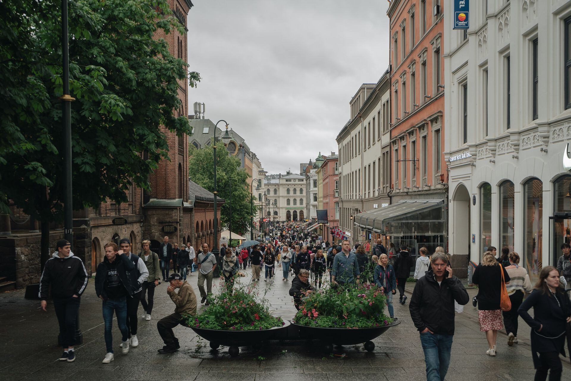 A photograph of people walking down Karl Johan in Oslo