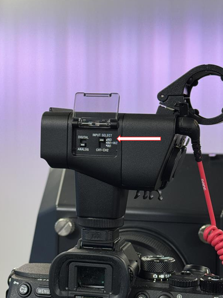 Arrow pointing to the input selector on the XLR adapter