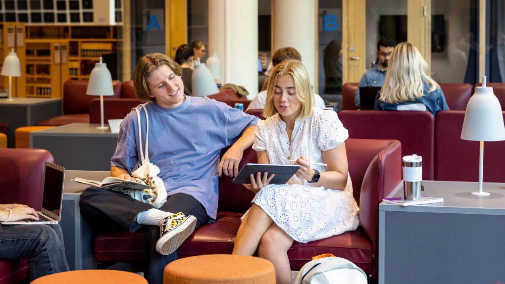 two students sitting on a couch