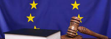 EU flag, book of law, judge's wooden hammer
