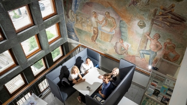 a group of student in a sofa group, photographed from above