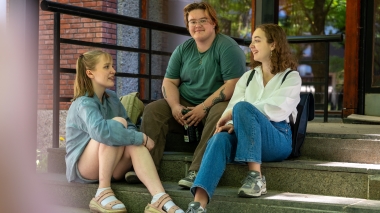 three student on a stairwell outside