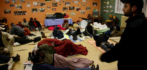 A group of people sleeping on the floor.