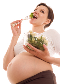 Gravid kvinne spiser salat
