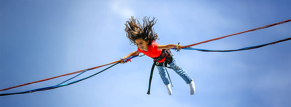 smiling girl bouncing in the air