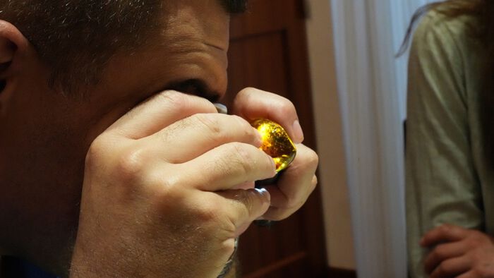 Man inspecting amber