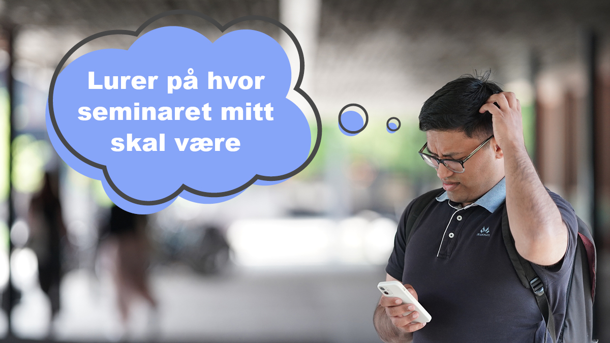 Mann som ser på en mobil og klør seg i hodet